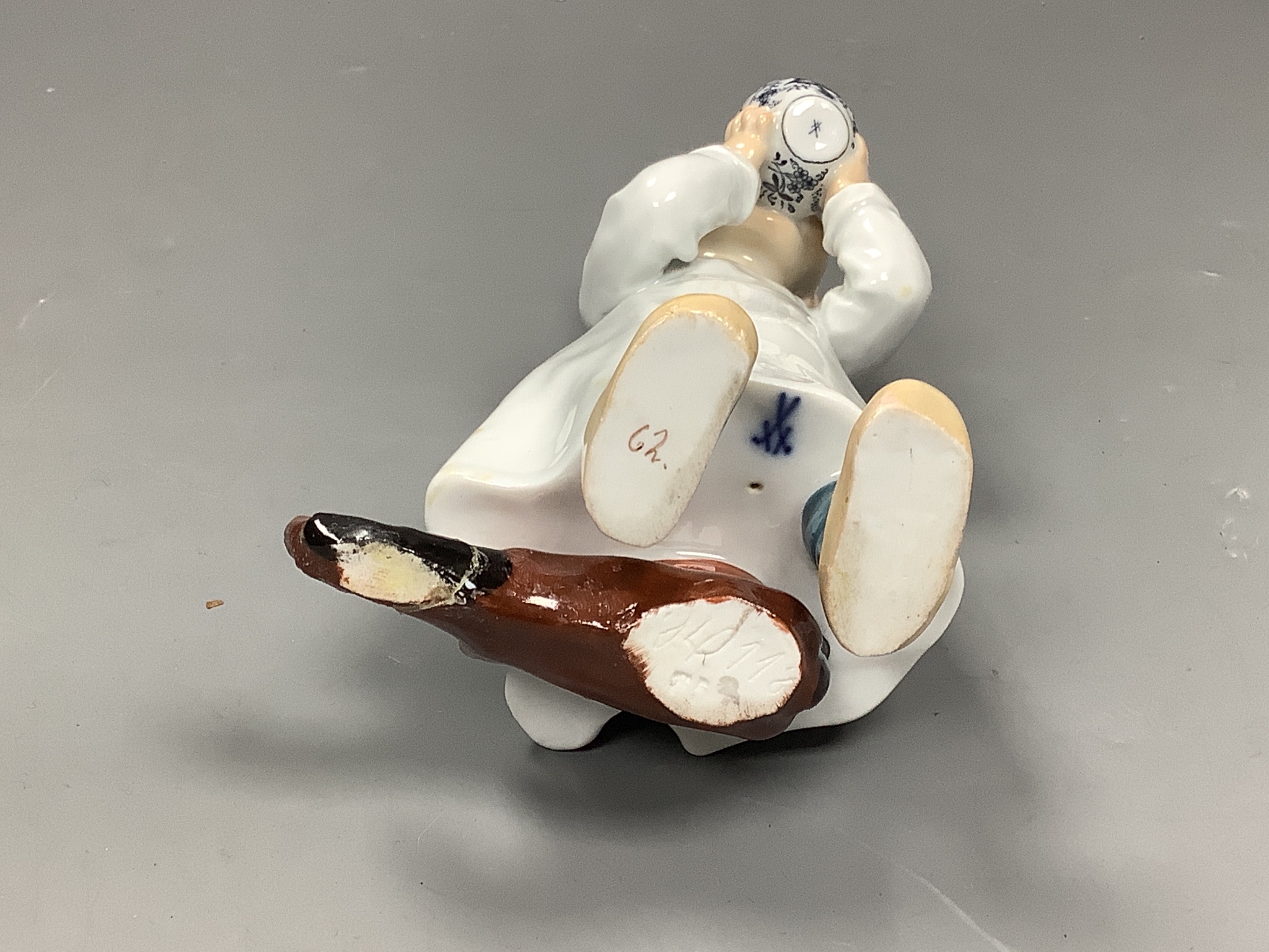 A Meissen figure of a child drinking from a bowl, modelled by Konrad Hentschel, c.1905-1924, 16cm high, faults